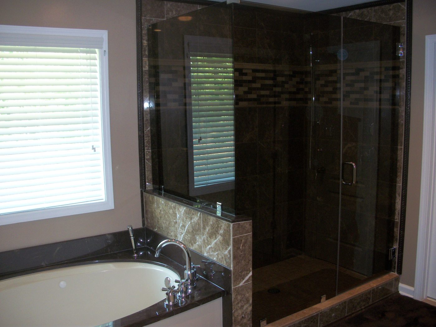 Luxury bathroom remodel with dark tile