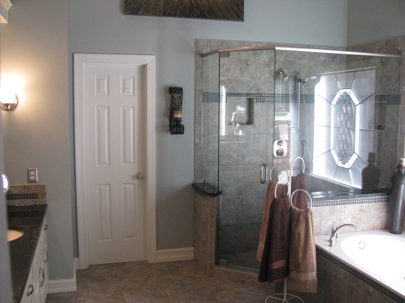 Spa-style bathroom with arched window